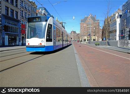 Tram driving on an empty Rokin in Amsterdam the Netherlands during the corona crisis