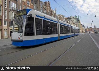 Tram driving on an empty Rokin in Amsterdam the Netherlands during the corona crisis