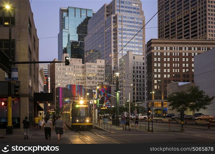 Tram on street amidst modern office buildings at Downtown Minneapolis, Hennepin County, Minnesota, USA