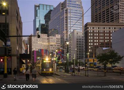Tram on street amidst modern office buildings at Downtown Minneapolis, Hennepin County, Minnesota, USA
