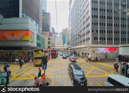 Tram or bus view. Crowd of people on street of Central district. Transportation for tourists visiting the urban city in travel trip or holiday. Fast speed at Hong Kong Downtown, China