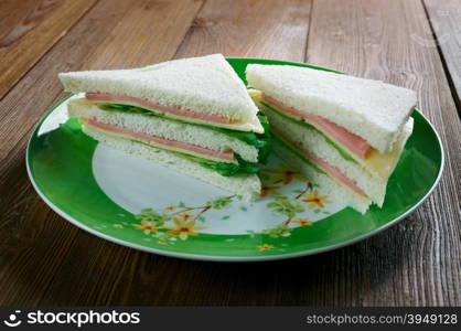 Tramezzino triangular sandwich constructed from two slices of soft white bread with the crusts.Italian cuisine