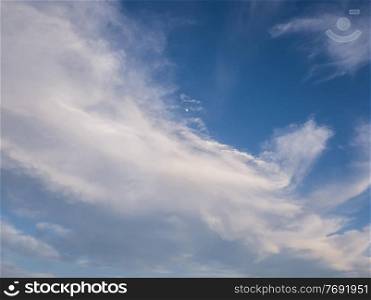 Tranquil cloudscape and the tiny moon on the blue sky. Fluffy white clouds aerial composition. Misty overcast cumulus shapes, abstract nebula textures. Air fresheners, celestial beauty
