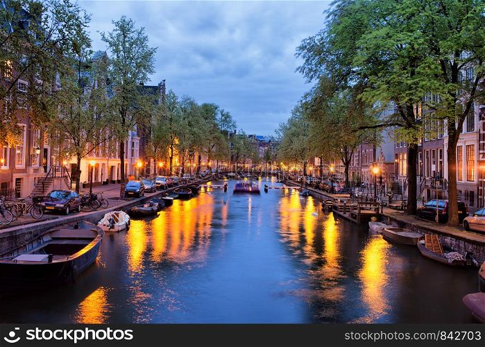 Tranquil evening by the canal in the city of Amsterdam, Netherlands, North Holland.