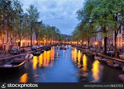 Tranquil evening by the canal in the city of Amsterdam, Netherlands, North Holland.