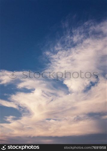 Tranquil evening cloudscape scene over the blue sky. Fluffy white clouds aerial composition. Misty overcast cumulus shapes, abstract nebula textures. Air fresheners, celestial beauty, vertical background