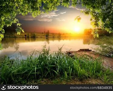 Tranquil fishing lake in the sunny evening