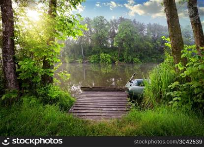 Tranquil fishing lake in the sunny evening . Fishing lake in sunny evening