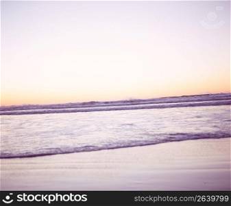 Tranquil ocean waves at sunrise
