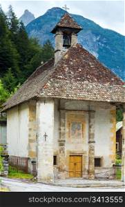Tranquil summer Italian dolomites mountain and village old chapel (Auronzo di Cadore, build in 1554)