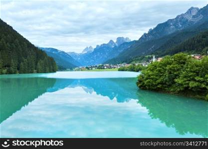 Tranquil summer Italian dolomites mountain lake and village view (Auronzo di Cadore)