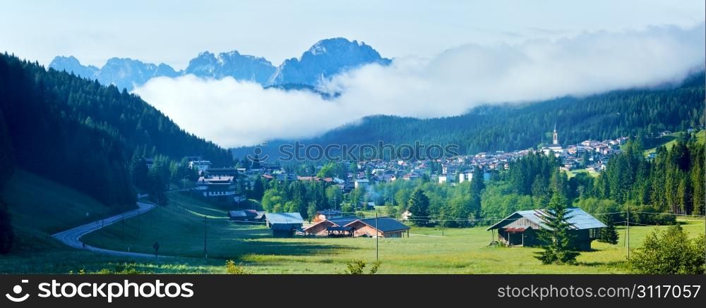 Tranquil summer Italian dolomites mountain panorama and village in valley