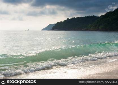 Tranquil tropical beach in summer, bright glittering on gently waves and surface of the sea. Koh Wua Ta Lap Island, Mu Koh Ang Thong National Park, Surat Thani, Thailand.