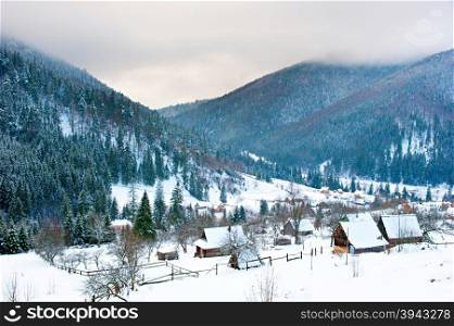 Transcarpathians village in the mountains covered by snow. Ukraine