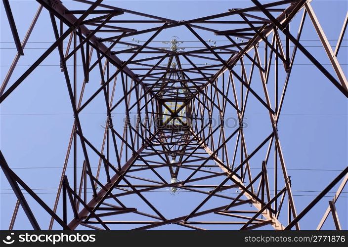 Transmission tower. Transmission tower as seen from below towards a blue sky
