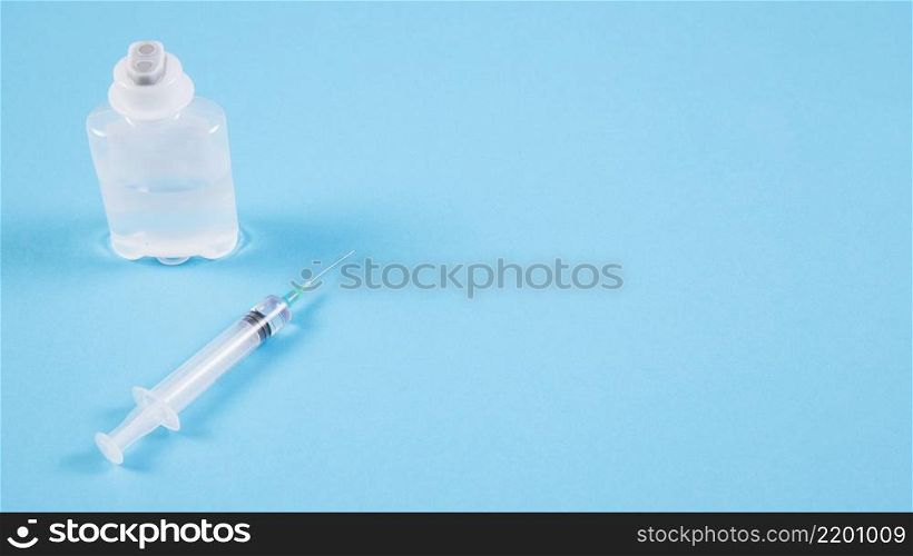 transparent ampoules syringe blue backdrop
