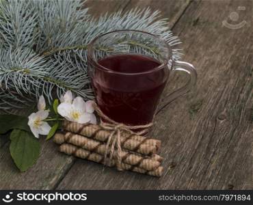 transparent cup of tea, fir-tree branch and floret, still life on