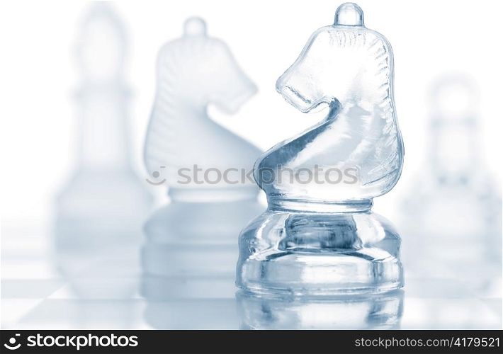 transparent glass chess pieces isolated on white