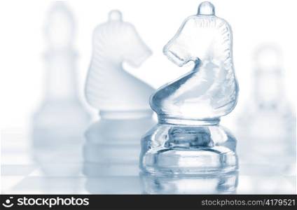 transparent glass chess pieces isolated on white