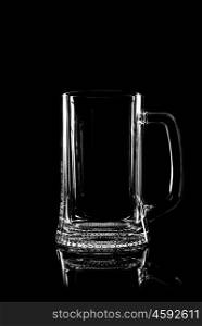transparent glass for beer on black background with reflection