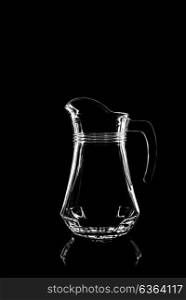 transparent glass for juice on black background with reflection