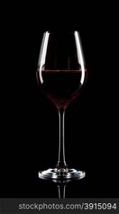 Transparent glass of red wine on black background