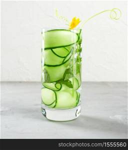transparent glass with cucumber pieces, mint leaves and mineral water, healthy lifestyle, detox