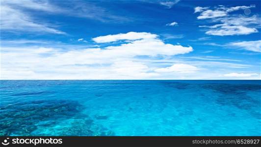 Transparent ocean and cloudy sky. Transparent ocean and cloudy sky. Tropical horizontal composition. Transparent ocean and cloudy sky