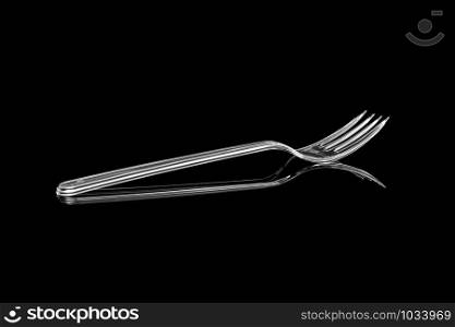 Transparent plastic fork isolated on black background. With clipping path
