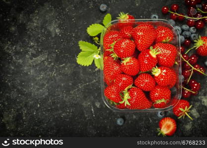 Transparent plastic tray with freshly picked strawberries