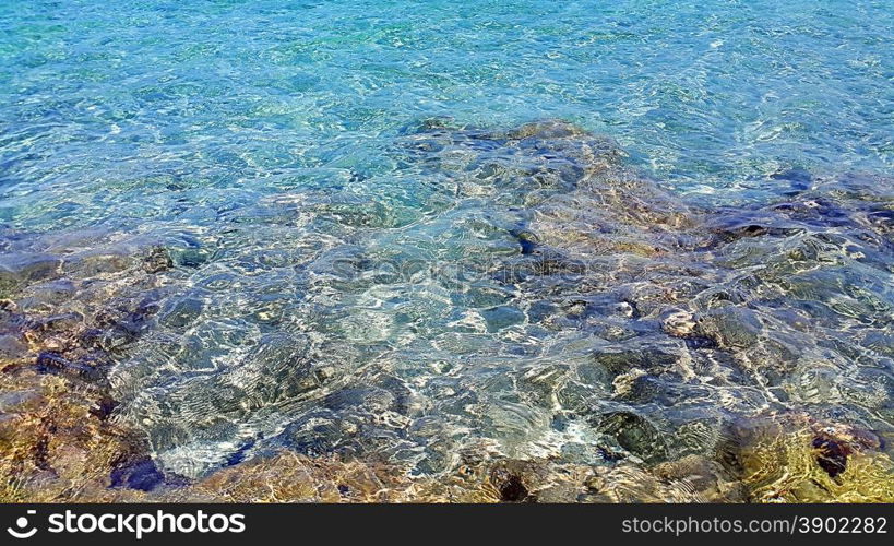 Transparent sea water near a rocky shore