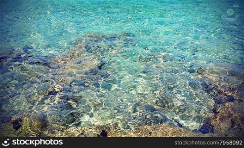 Transparent sea water near a rocky shore