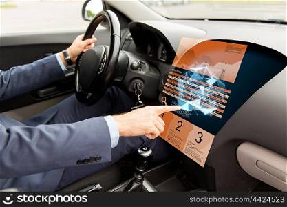 transport, business, modern technology and people concept - close up of man driving car and pointing finger to chart and low poly shape on board computer screen