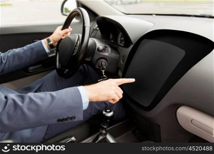 transport, business, modern technology and people concept - close up of man driving car and pointing finger to blank on-board computer screen