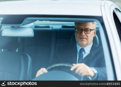 transport, business trip and people concept - happy senior businessman driving car. happy senior businessman driving car