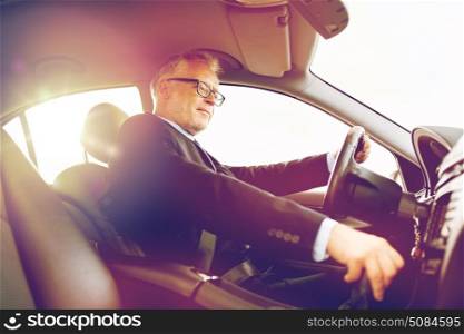 transport, business trip and people concept - happy senior businessman driving car. happy senior businessman driving car. happy senior businessman driving car