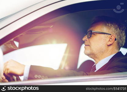 transport, business trip and people concept - happy senior businessman driving car. happy senior businessman driving car