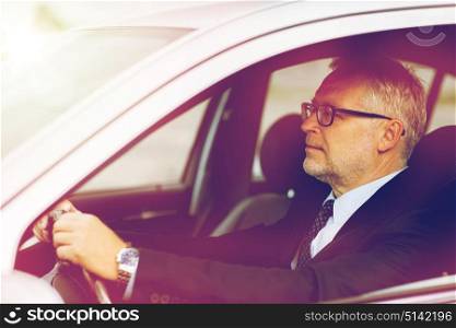transport, business trip and people concept - happy senior businessman driving car. happy senior businessman driving car