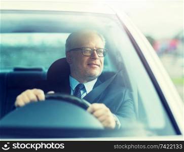 transport, business trip and people concept - happy senior businessman driving car. happy senior businessman driving car