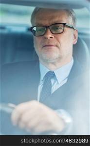 transport, business trip and people concept - senior businessman driving car