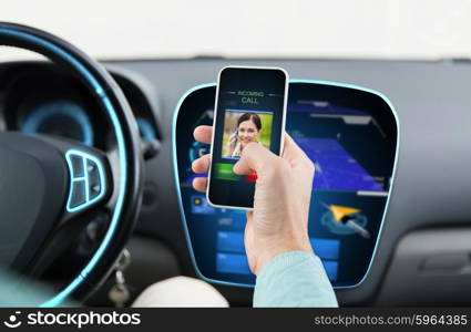 transport, business trip, communication, technology and people concept - close up of male hand with incoming video call icon on smartphone screen in car