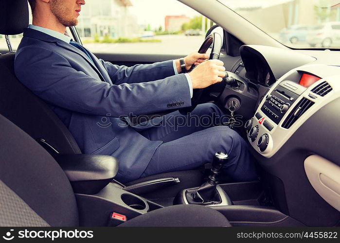 transport, business trip, destination and people concept - close up of young man in suit driving car