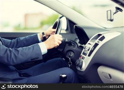 transport, business trip, destination and people concept - close up of young man in suit driving car