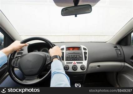 transport, business trip, destination and people concept - close up of young man driving on car parking