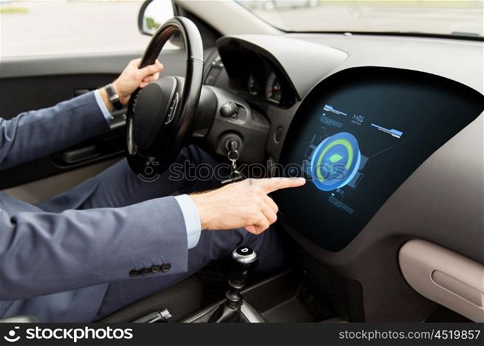 transport, business trip, green energy, technology and people concept - close up of man driving car and using eco system mode on board computer