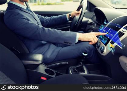 transport, business trip, navigation, technology and people concept - close up of young man in suit driving car and using gps navigator system on board computer screen