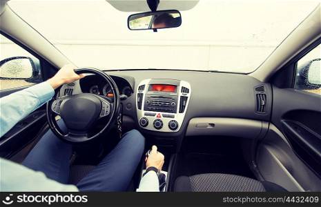 transport, business trip, speed, destination and people concept - close up of young man driving on car parking