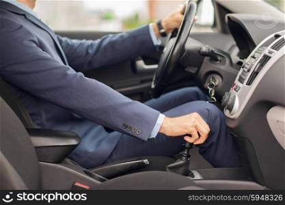 transport, business trip, speed, destination and people concept - close up of young man in suit driving car