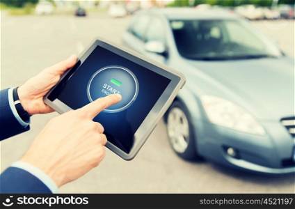 transport, business trip, technology and people concept - close up of male hands pushing start engine button on tablet pc computer screen with car outdoors