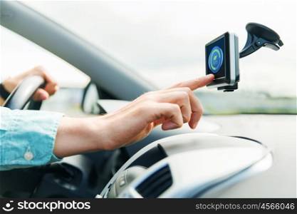 transport, business trip, technology and people concept - close up of male hand pointing to eco mode icon on gadget screen while driving car